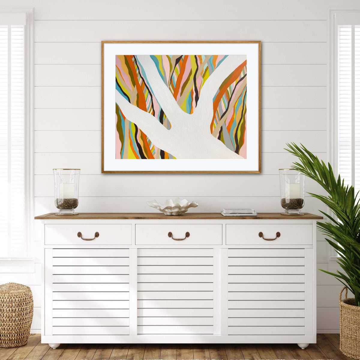 Brilliant Blue Gum framed print displayed above a white console table in an entryway