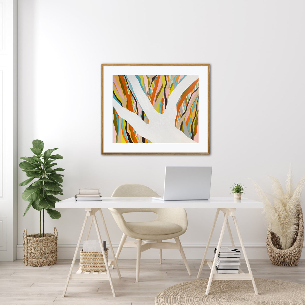 Brilliant Blue Gum framed print displayed on a wall in a bright home office with a plant