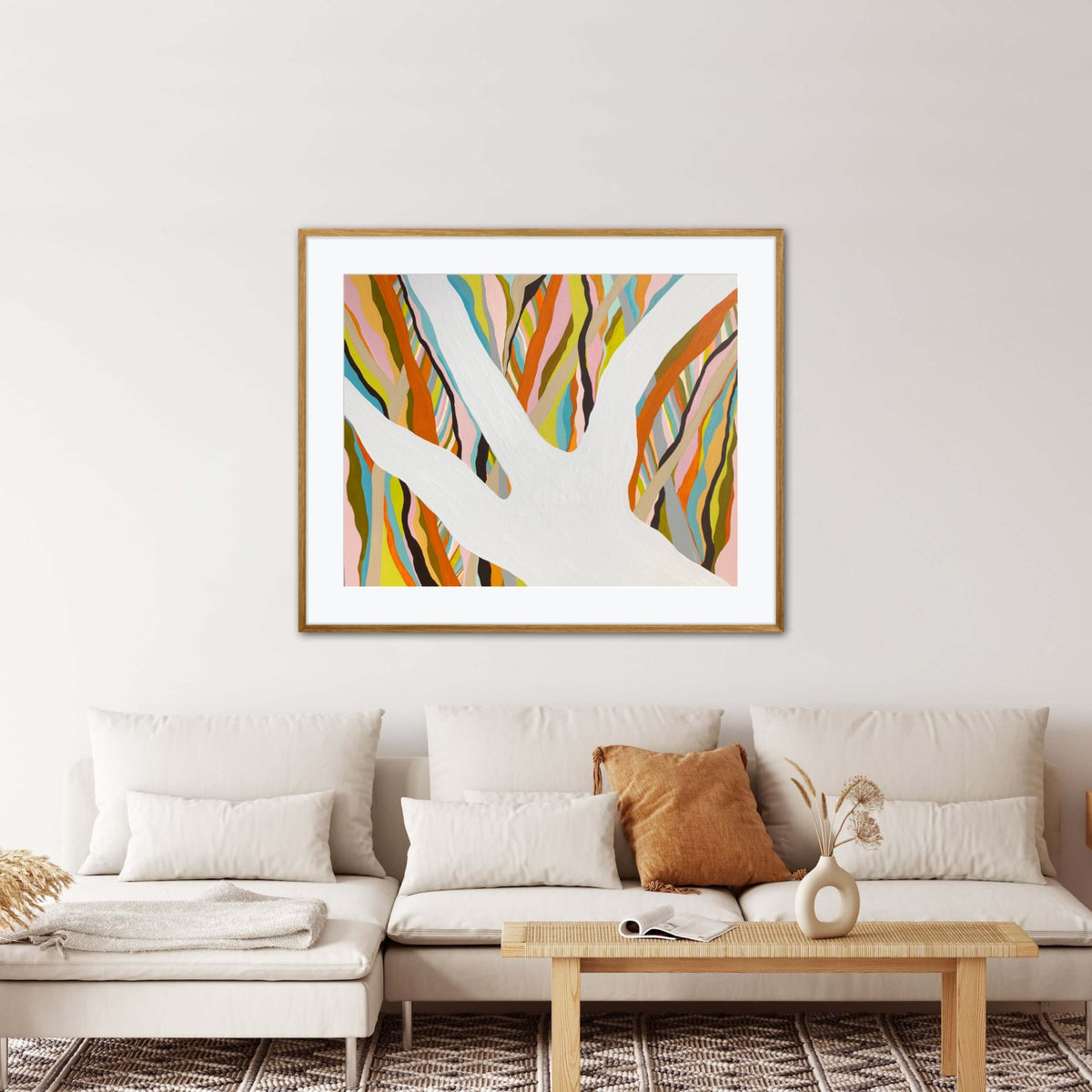 Brilliant Blue Gum framed print displayed in a living room with neutral lounge and wicker coffee table 