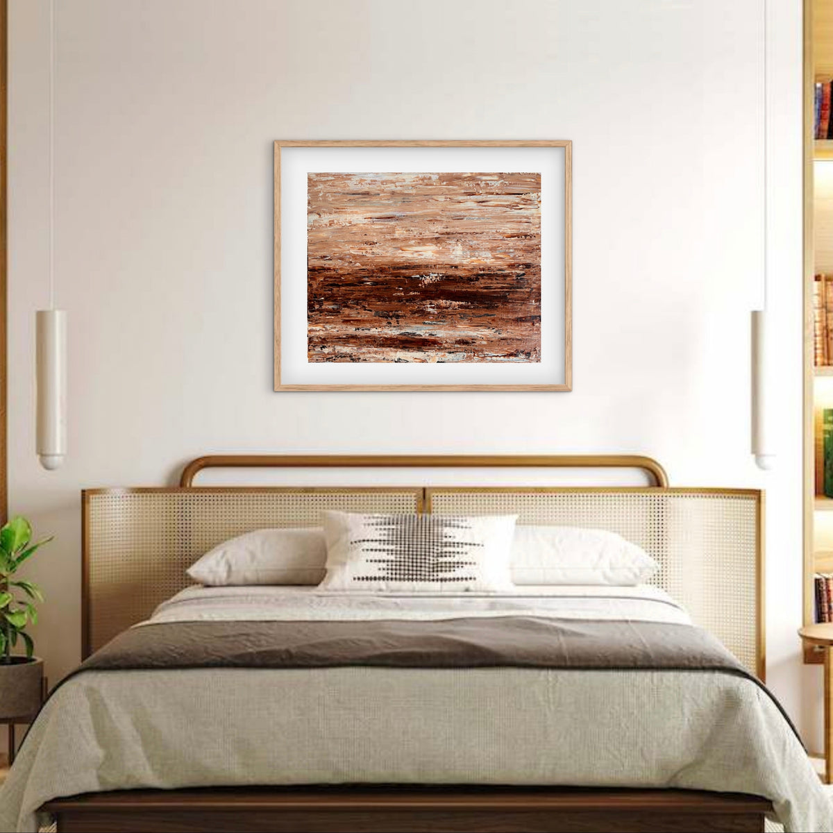 Burnished Earth framed print displayed above a bed with a cane headboard