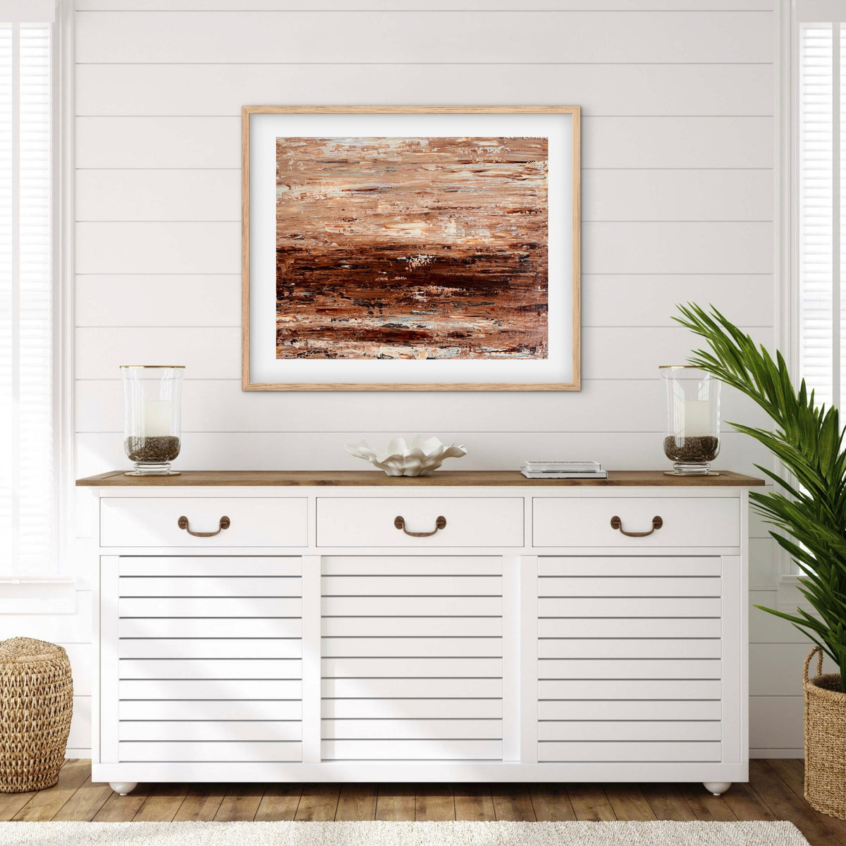 Burnished Earth framed print displayed above a console table in a coastal-style entryway