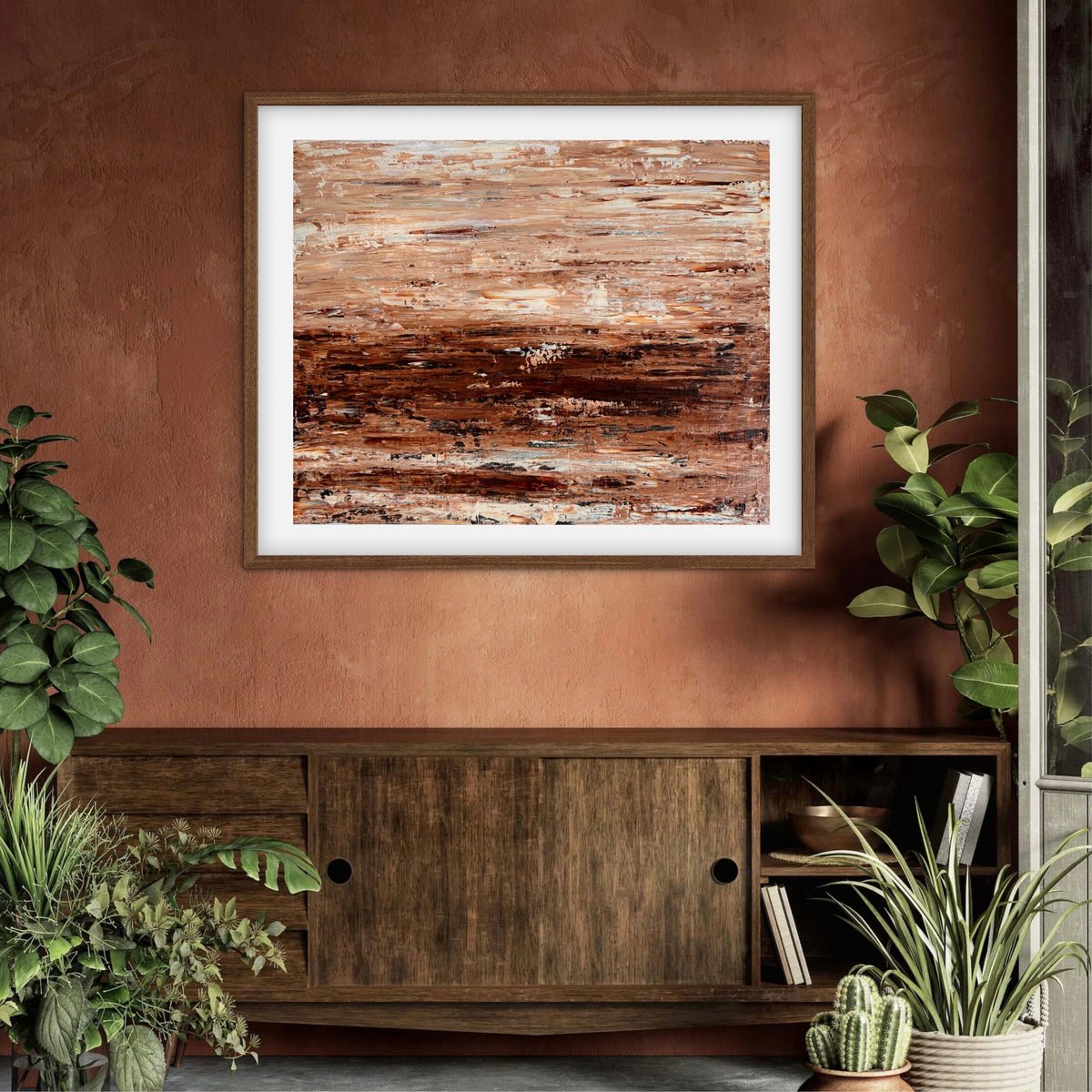 Burnished Earth framed print displayed above a wood sideboard against a terracotta wall