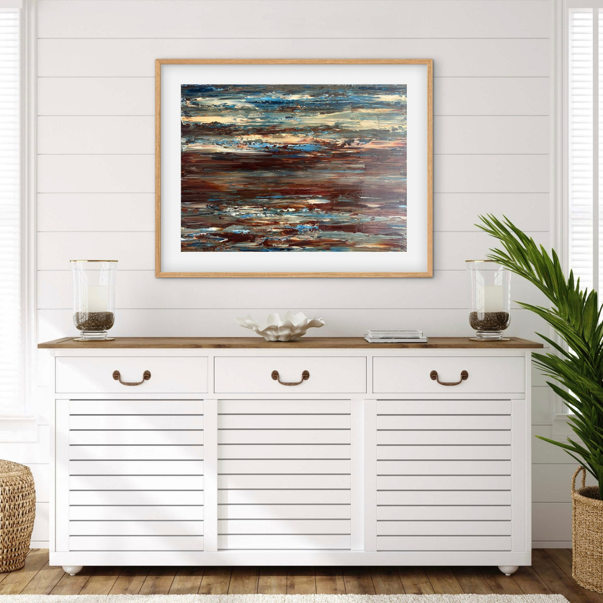 Coastal Drift framed print displayed above a console table in a coastal-style entryway