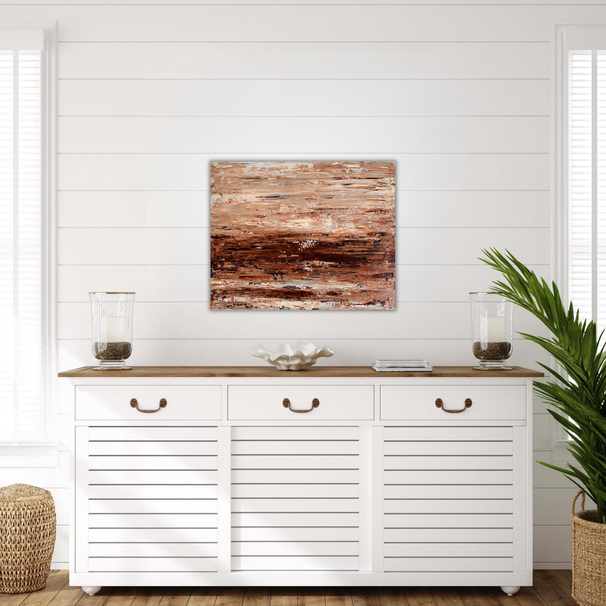 Burnished Earth original abstract painting displayed above a light wood console in a bright neutral interior