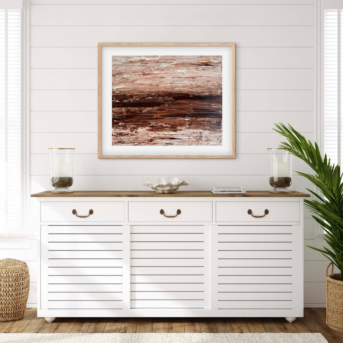 Ocean & Earth I framed print displayed above a console table in a coastal-style entryway