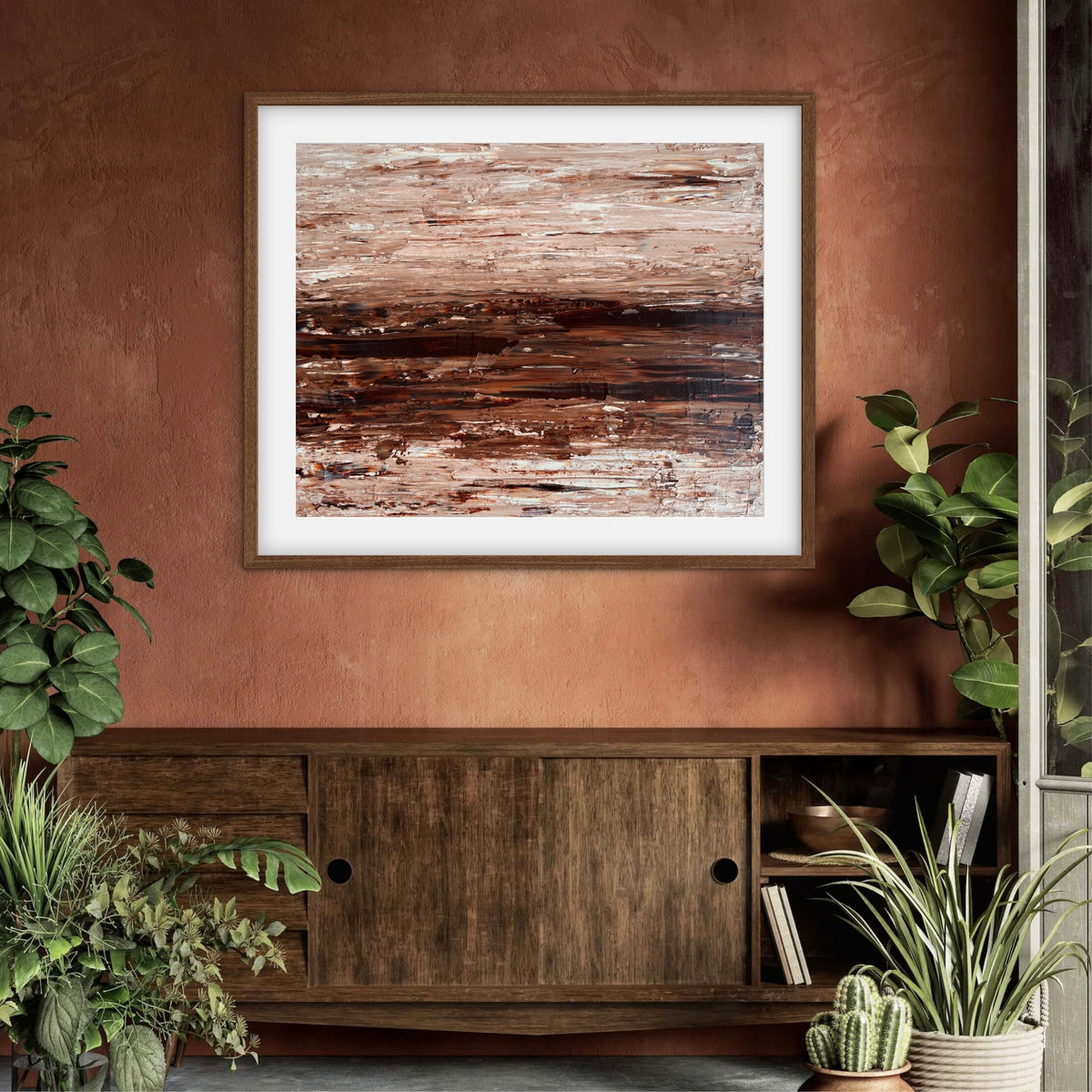 Ocean & Earth I framed print displayed above a wood sideboard against a terracotta wall