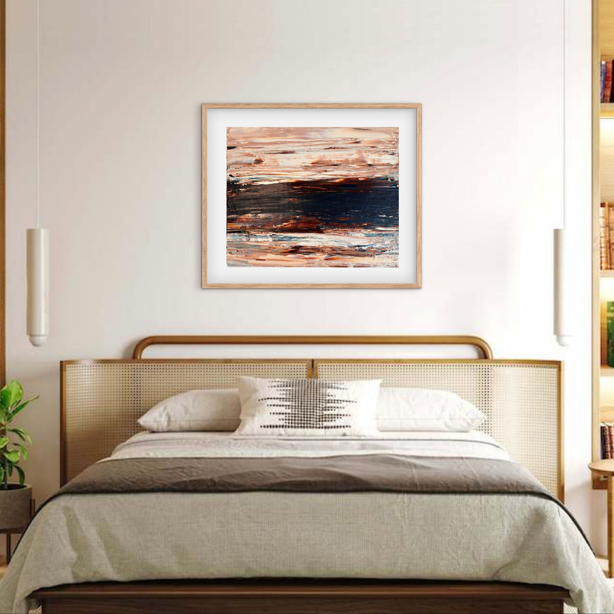 Ocean & Earth II framed print displayed above a bed with a cane headboard