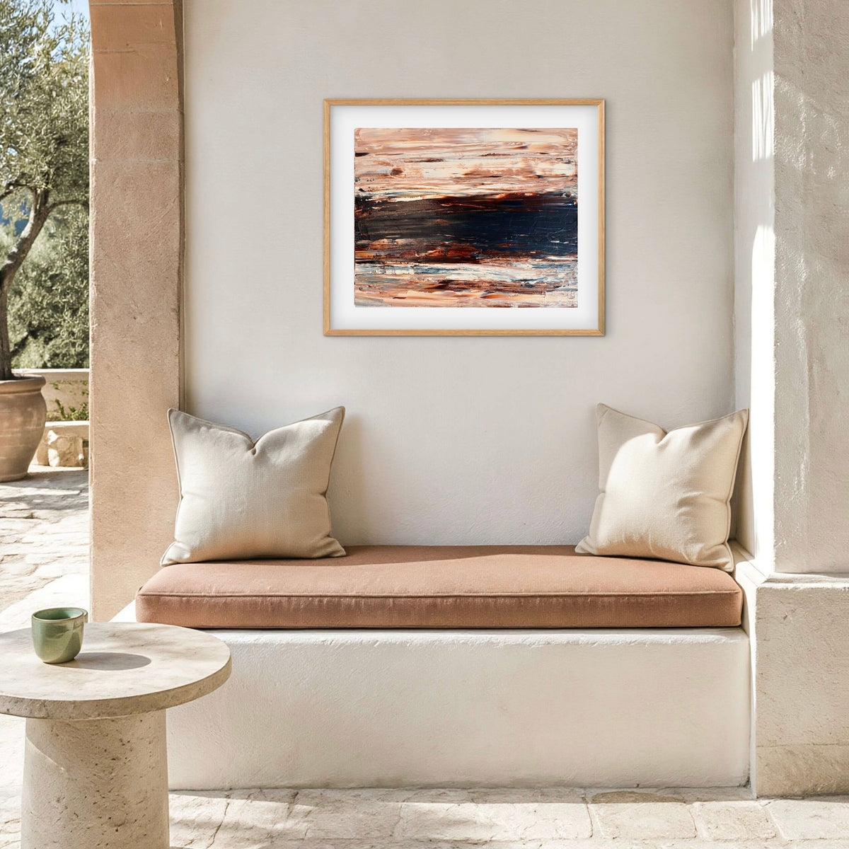 Ocean & Earth II framed print displayed above an outdoor patio nook with cushions