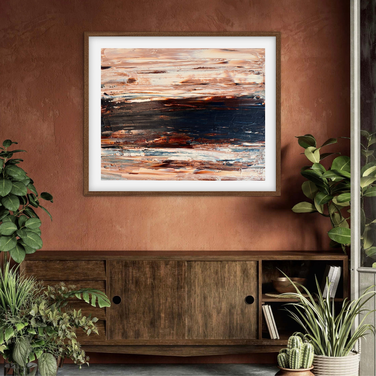 Ocean & Earth II framed print displayed above a wood sideboard against a terracotta wall