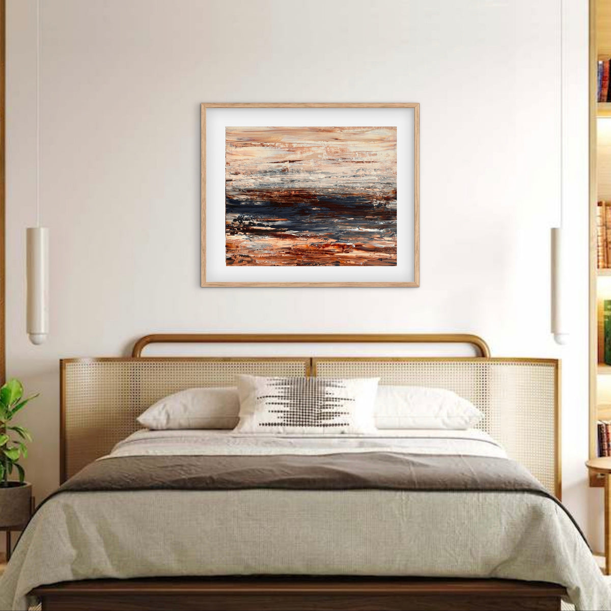 Ocean & Earth III framed print displayed above a bed with a cane headboard