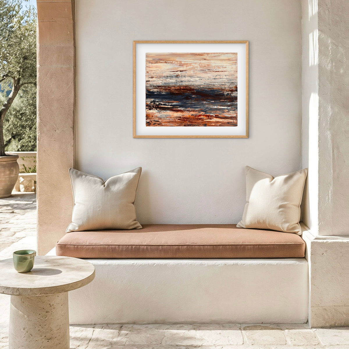 Ocean & Earth III framed print displayed above an outdoor patio nook with cushions
