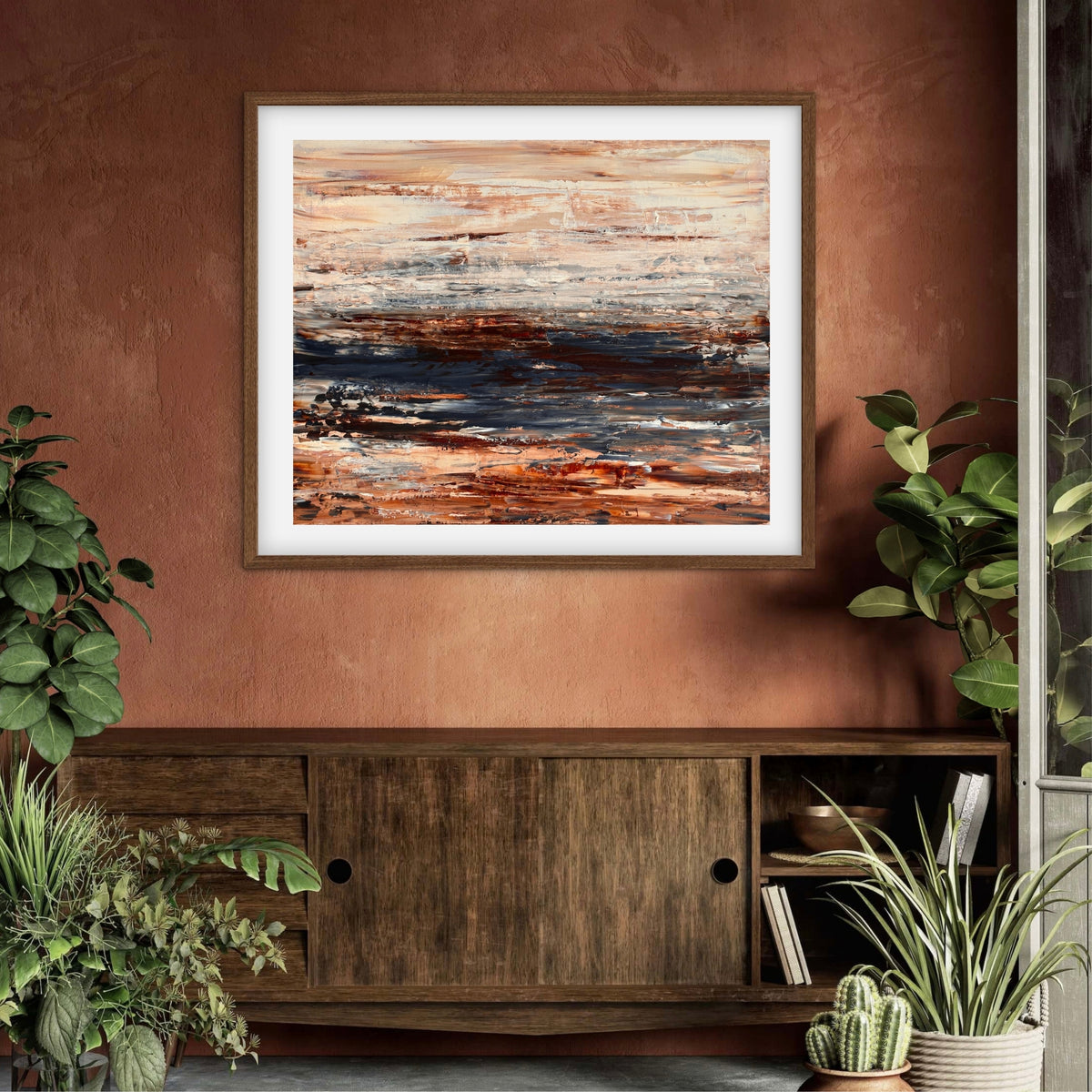 Ocean & Earth III framed print displayed above a wood sideboard against a terracotta wall