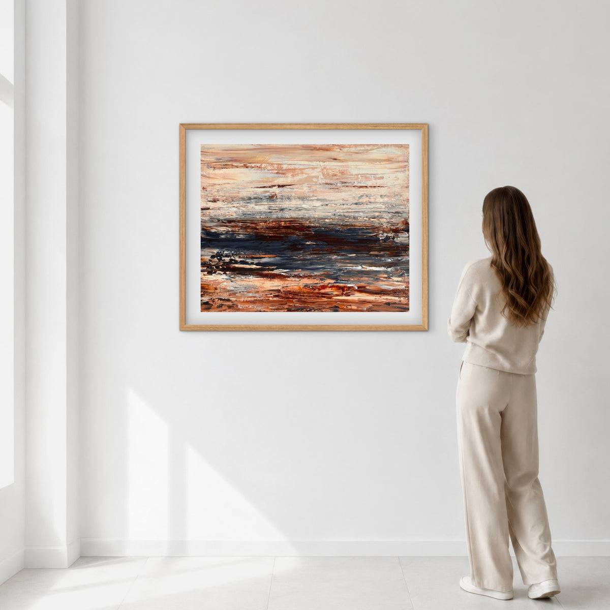 Ocean & Earth III framed print displayed above a bed with a cane headboard