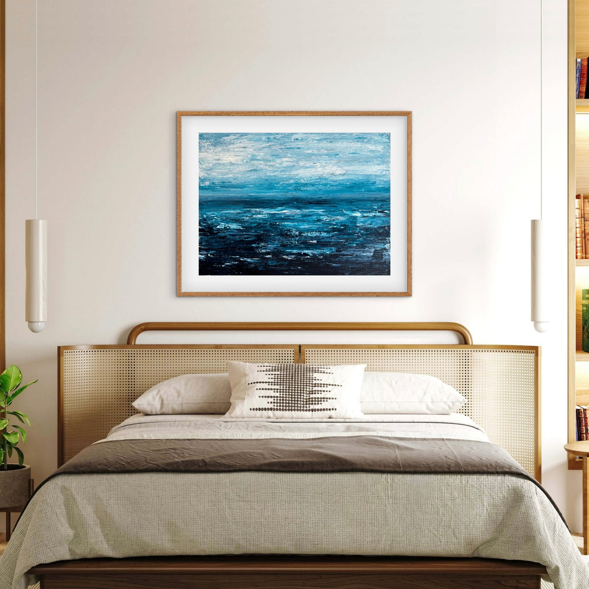 Quiet Tide framed print displayed above a bed in a light, neutral bedroom